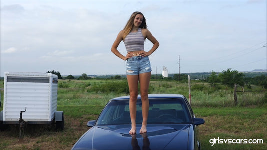 2 aspiring models pose and jump on a car